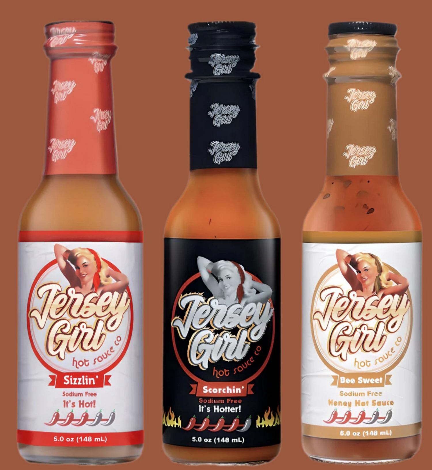 Three bottles of Jersey Girl hot sauce on a brown background