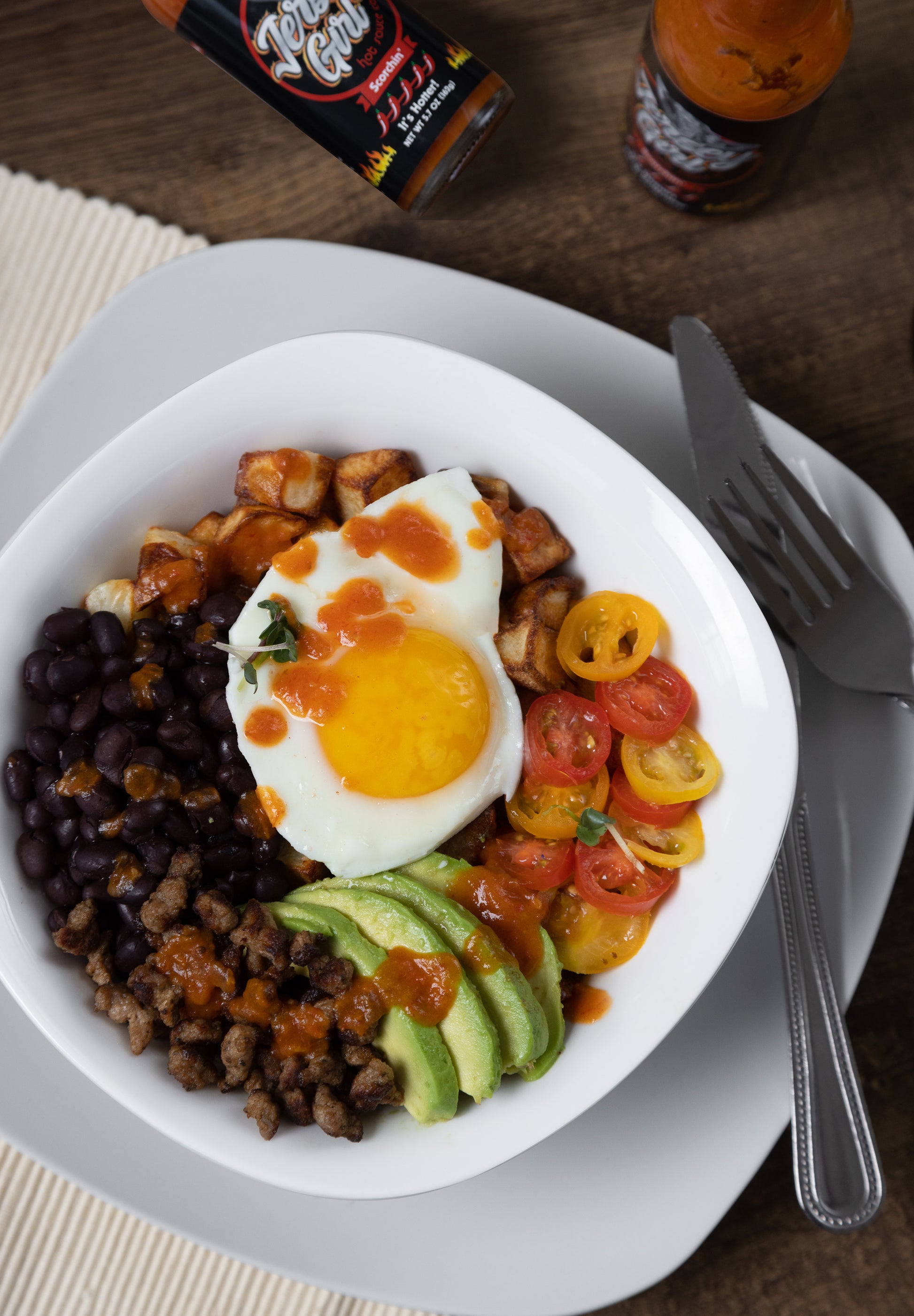 Jersey Girl Hot Sauce - Scorchin' shown on a bowl of Eggs, Beans, Sausage, tomatoes, and avacado